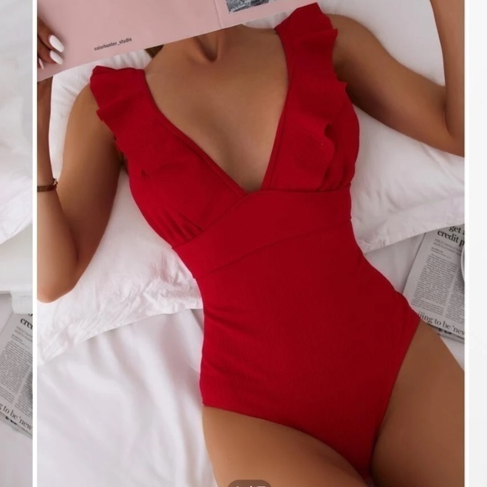One pice ruffle swim suit with ties in the back.
